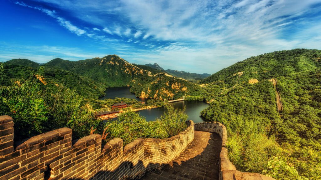 A picture of the great wall of China with a forest in the background